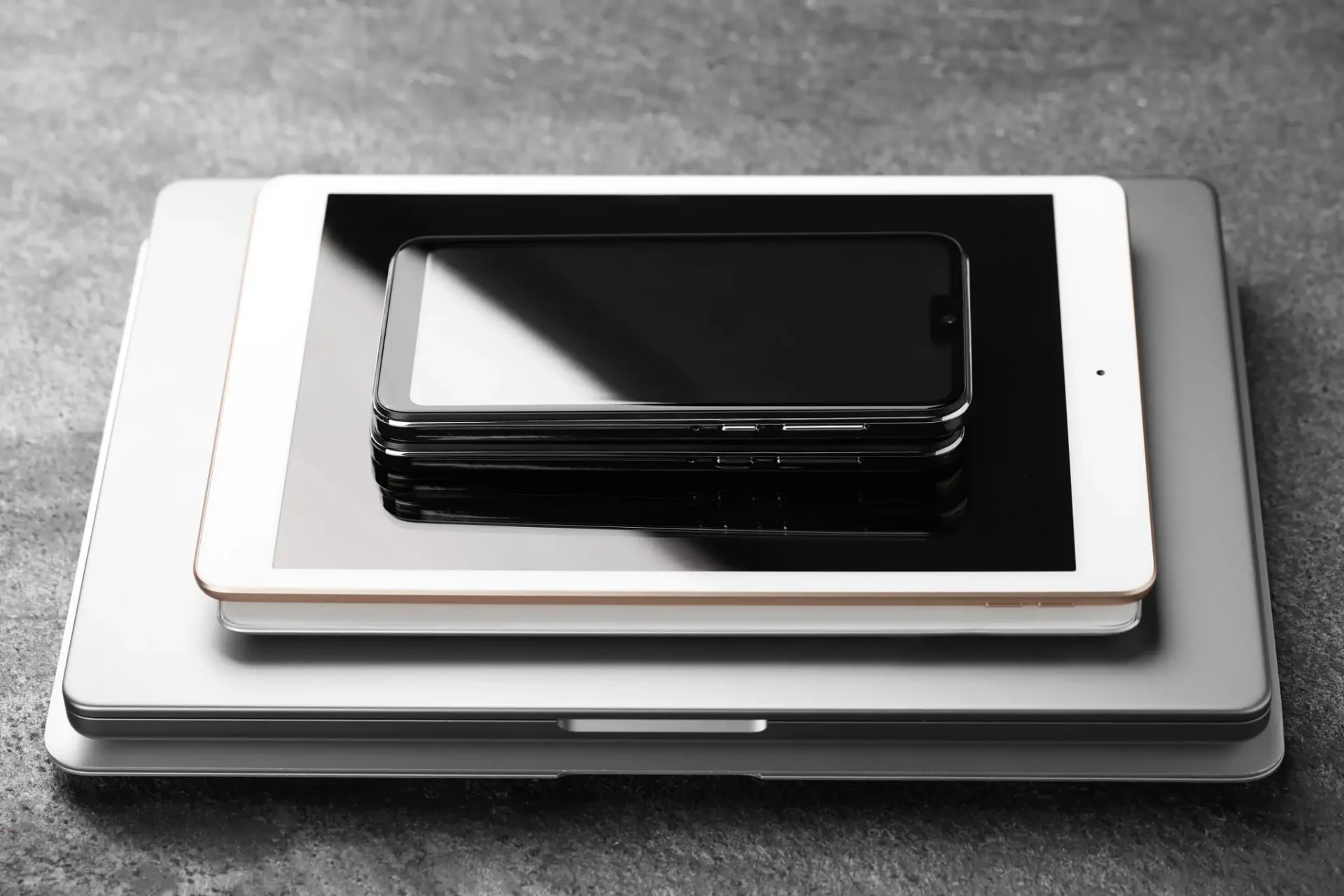 Stacked laptop, tablet, and smartphones