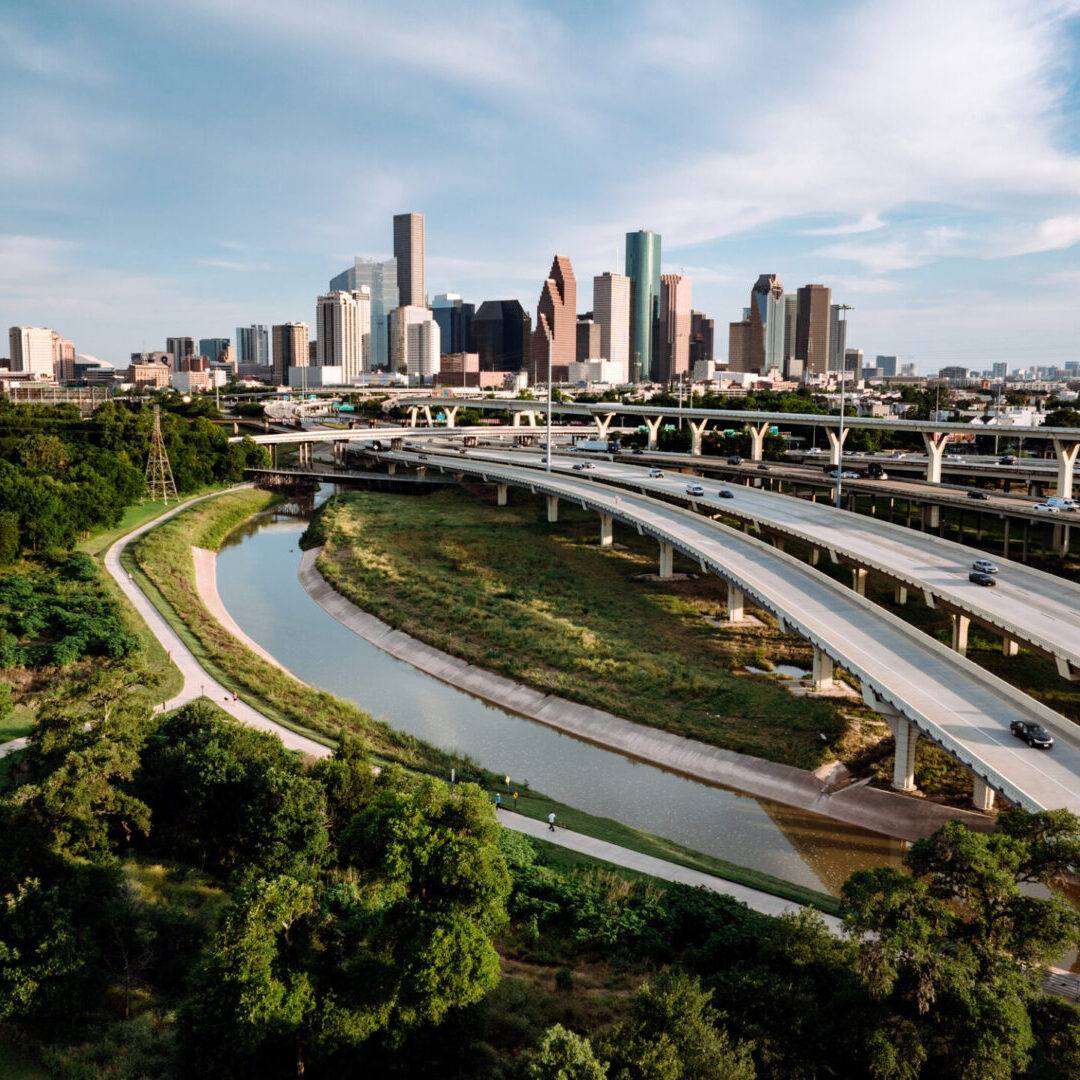 Houston skyline with highways and greenery.